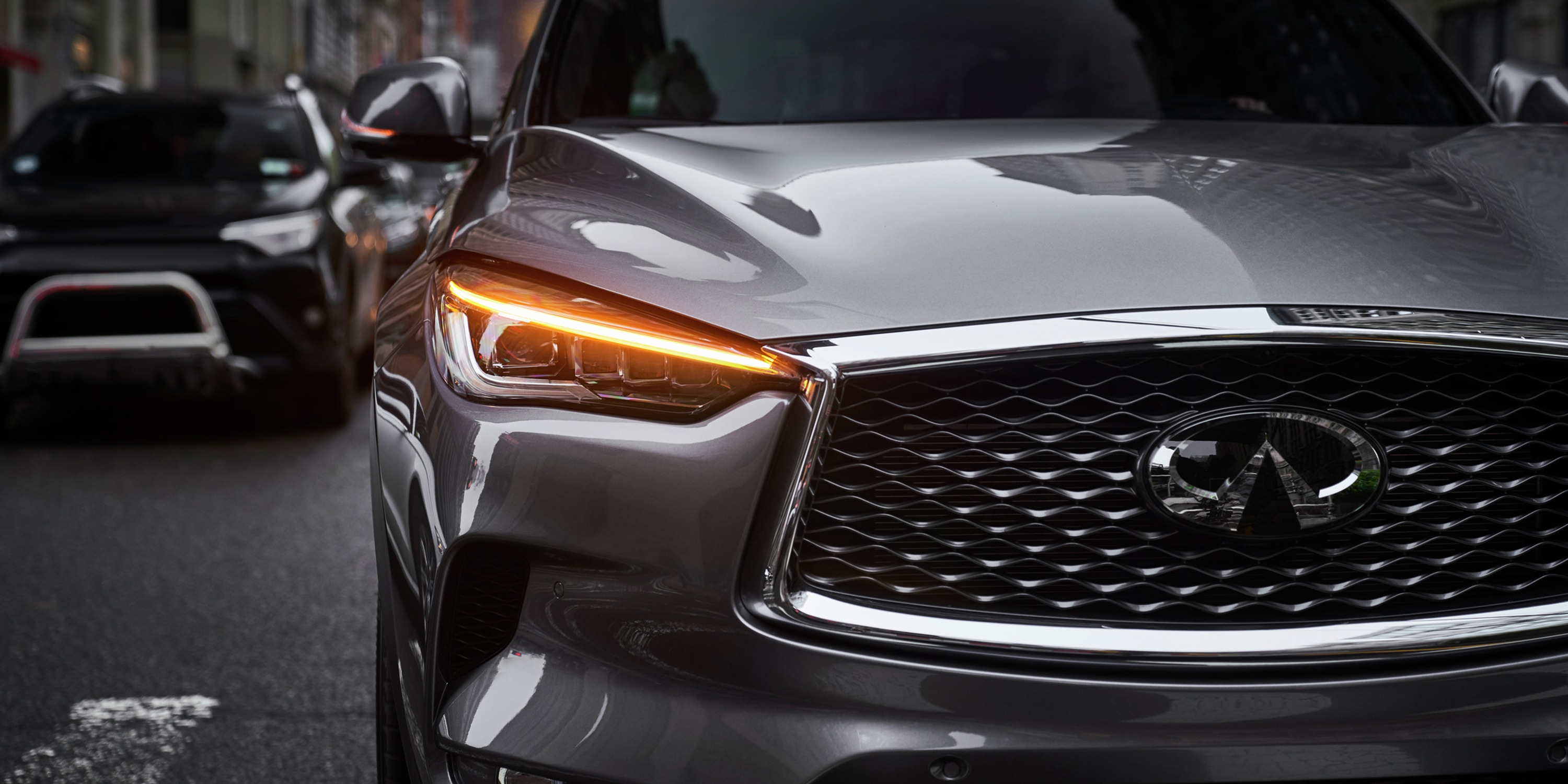 Front profile of a 2021 INFINITI QX50 with its turn signal on