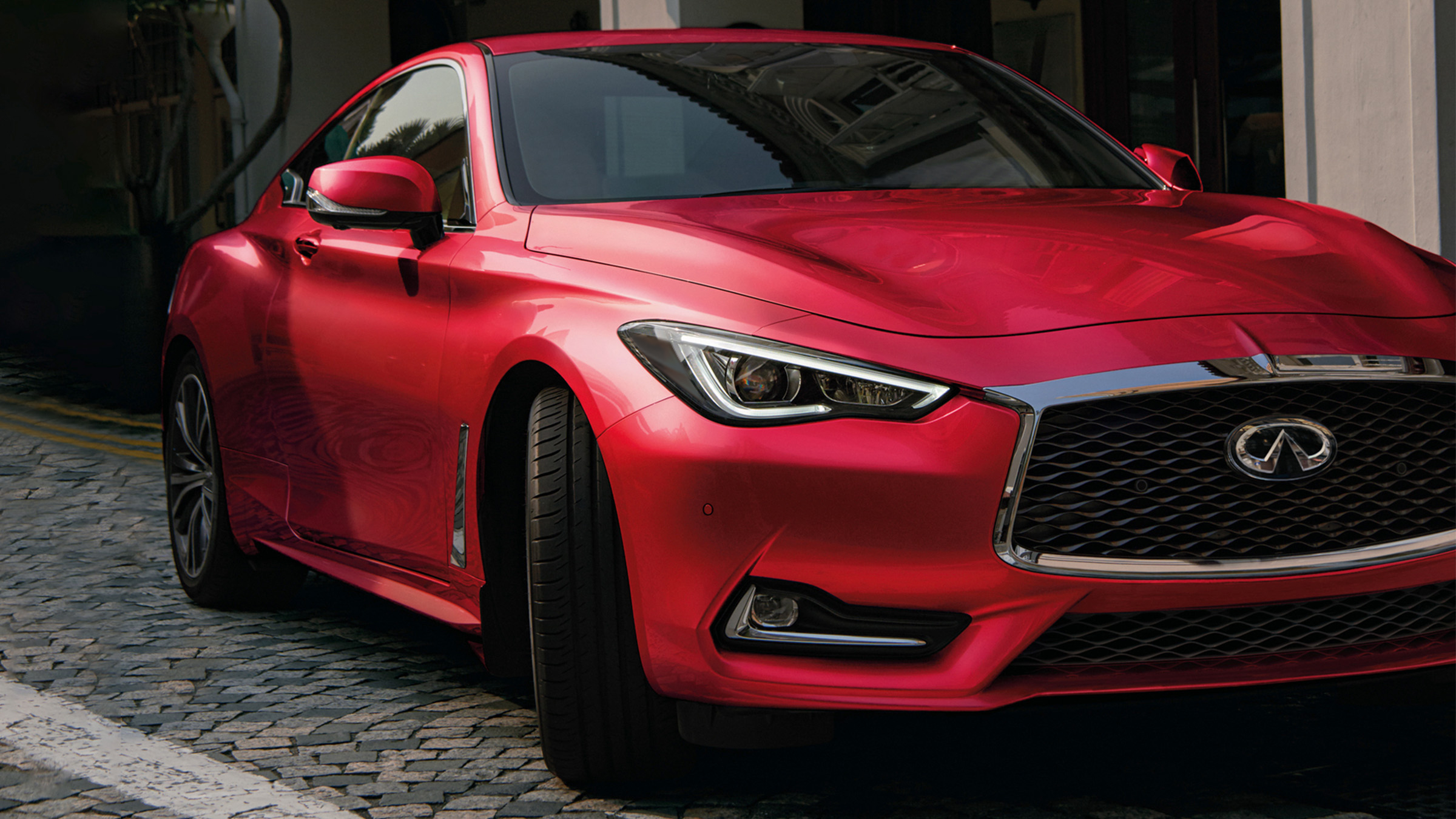 2022 INFINITI Q60 red car parked on the road.
